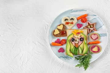 Fototapeta na wymiar Creative breakfast for children on plate. Recipe ideas with bread