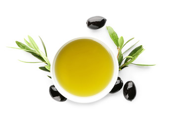 Bowl with black olives and oil on white background