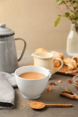 Fototapeta na wymiar Cup of aromatic tea with milk on table