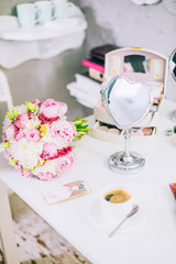 Wedding rings on macaroon in hands of the bride. Bride's morning concept, Gentle composition. Woman looking in the mirror