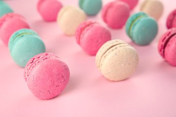Delicious macarons on color background
