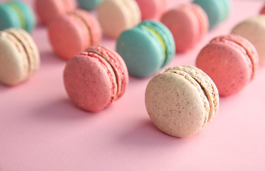 Delicious macarons on color background