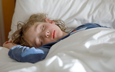 Petit garçon dort paisiblement, joli visage détendu, cheveux sur l'oreiller   © Irena Begusic