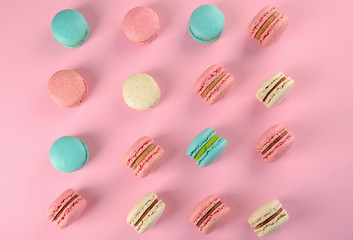 Delicious macarons on color background, flat lay