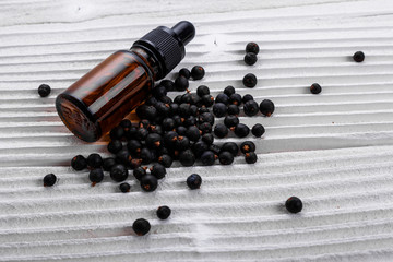 juniper essential oil on a white background