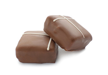 Tasty milk chocolate candies on white background