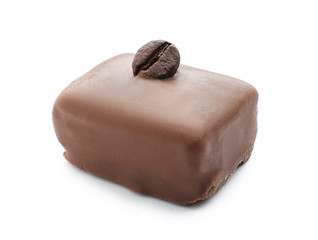 Tasty chocolate candy with coffee bean on white background