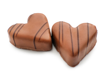 Tasty heart-shaped chocolate candies on white background