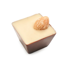 Tasty chocolate candy with nut on white background
