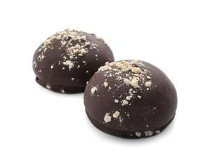 Tasty dark chocolate candies on white background