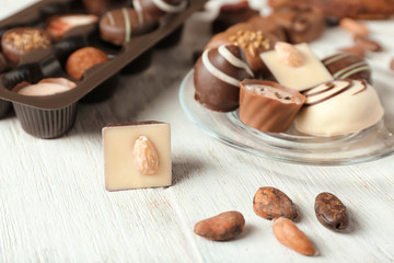 Tasty chocolate candies on wooden table