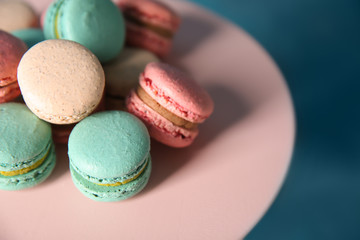 Dessert stand with tasty macarons on table, closeup