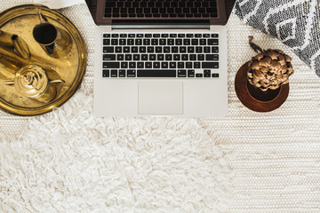 Top view decorated home office desk workspace laptop. Flat lay modern styled business concept. Blog or social media hero header. Minimal boho background.