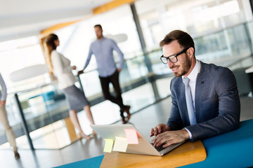 Young employee working on computer during working day in office