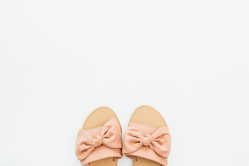Pink female slippers on white background. Flat lay, top view. Summer fashion concept.