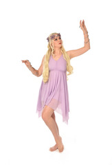 full length portrait of pretty blonde girl wearing purple fairy dress. standing pose, isolated on white studio background.