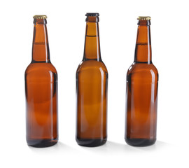 Glass bottles of beer on white background