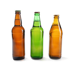 Glass bottles of beer on white background