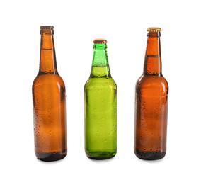 Glass bottles of beer on white background
