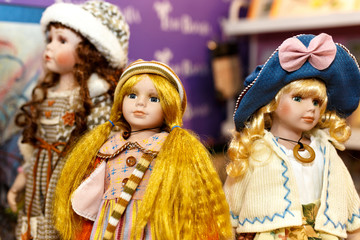 Collection of old porcelain dolls placed in baby room