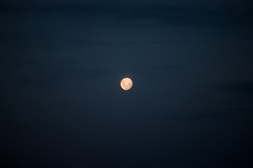 Full moon in cloudy night.