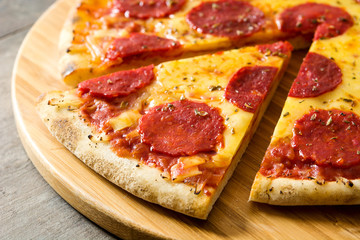 Hot italian pepperoni pizza on wooden table. 