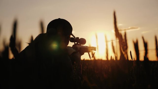 A sniper rifles from a rifle with an optical sight. On the Sunset. Sports shooting and hunting concept