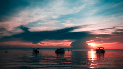 Naklejka na ściany i meble Beautiful sunset with speed boats