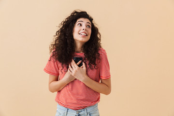 Emotional excited happy young woman using mobile phone.