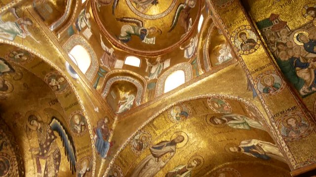 Palermo, Italy - April 28, 2018: Christ in the dome beautiful Byzantine mosaics of the 12th century and the newer part is decorated with later frescoes the 18th century in the Martorana church.