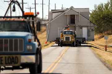 Oversize load - structural house mover with two-storey home on highway