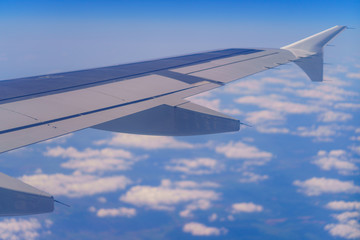 Wing of aircraft over the clouds