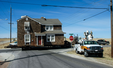 Oversize load - structural house mover with two-storey home on highway