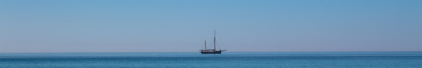 Fototapeta premium Sailboat on the horizon panorama