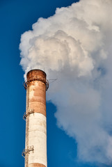 Thick smoke from industrial pipe of factory