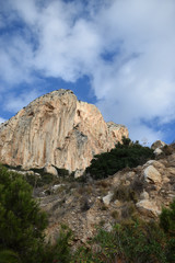 A beautiful view of Mount Ifach In Spain, the city of Calpe and the blue Spanish sky with white clouds