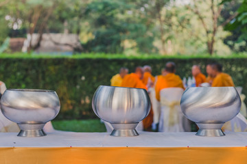 To make merit by offering food to monk ceremony in Thai wedding tradition.Selective focus on alms bowl.