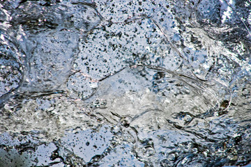Abstract blurred background of a moving water flow close up