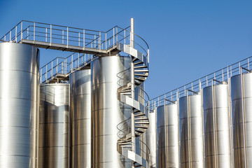 Silver wine Silos with blue sky in background © steuccio79