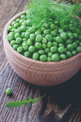 Fresh green peas in wooden bowl, vegan food