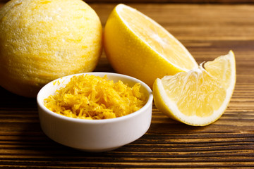 Lemon and juice on a wooden background