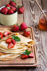 Crepes with fresh strawberries and organic honey for breakfast