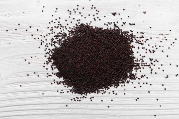 fresh amaranth grains on a rustic background