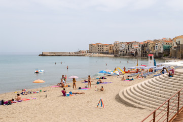 Obraz premium View of the beach of Cefalu with the old city in the background