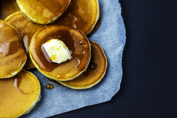 freshly prepared pancakes with maple syrup for breakfast