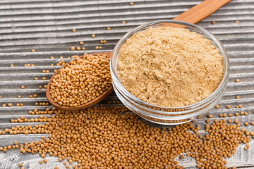 mustard in a bowl on a rustic background