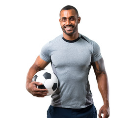 Strong football player with soccer ball and smiling on isolated white background