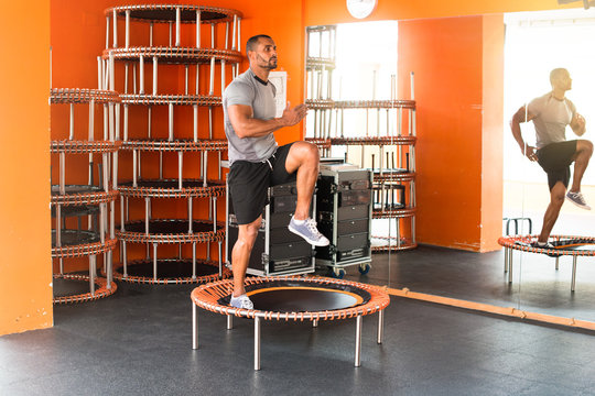 Sport man in the gym making body jump