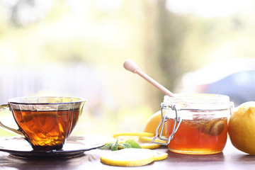 Fresh honey with a cup of black tea
