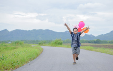 Happy fat boy running with balloon